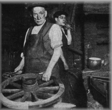 Old smith measuring a wheel rim in the forge
